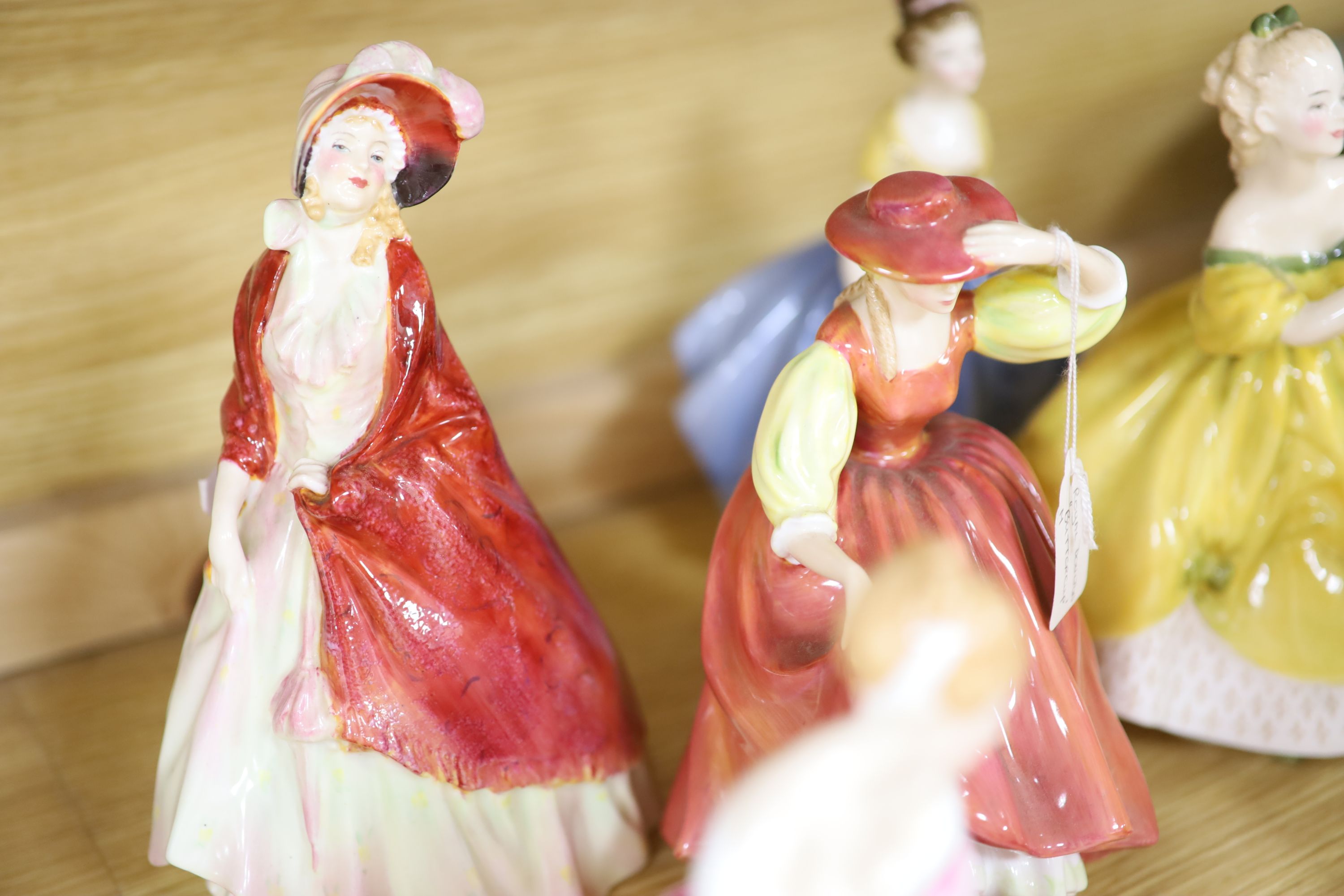 A collection of fourteen Royal Doulton figures